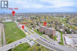 Aerial perspective showcasing a multi-story residential building surrounded by green spaces and urban infrastructure - 