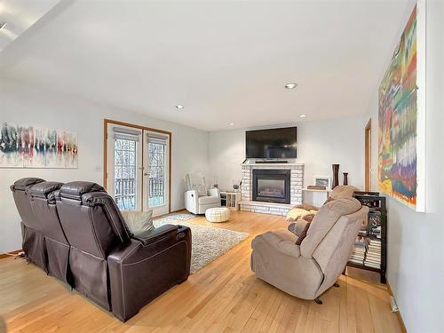 106 Braeview Place, Brandon, MB - Indoor Photo Showing Living Room With Fireplace