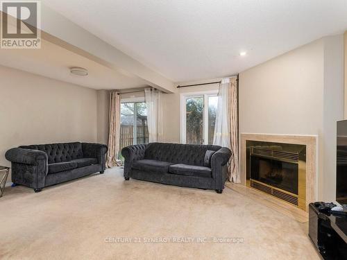 L shaped living/dining room with wood  fireplace - 1 Winnegreen Court, Ottawa, ON 
