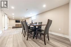 Open-concept finished lower level featuring recessed lighting, light wood-finish flooring, and neutral wall tones - 