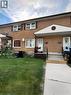 Brick facade exterior featuring white vinyl windows and dark shutters **Virtually Staged** - 148 Bishop Street S, Cambridge, ON 