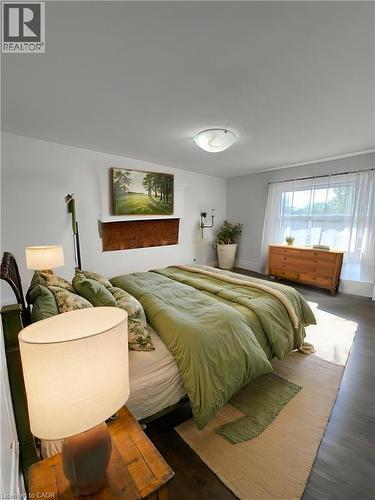 Spacious room featuring dark wood-finish flooring and light-toned walls **Virtually Staged** - 148 Bishop Street S, Cambridge, ON 