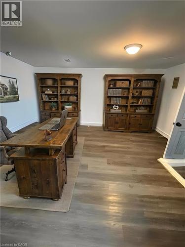 Spacious room featuring wood-finish flooring and white walls **Virtually Staged** - 148 Bishop Street S, Cambridge, ON 