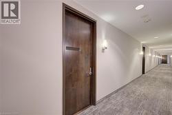 Hallway with wood-finish doors and light-toned walls - 