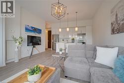 Open-concept living area with light wood-finish flooring - 