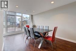 Building  Party Room ,Dining space featuring rich wood-finish flooring and recessed lighting - 