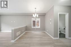 This bright and neutral space features light-colored flooring, neutral-toned walls, and white trim - 