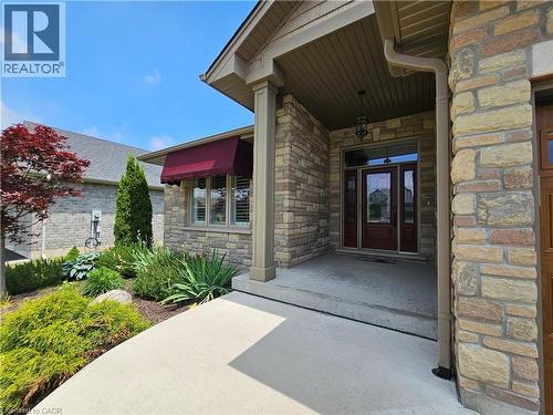 Stone facade entry featuring a covered porch - 98 Allandale Crescent, Simcoe, ON - Outdoor