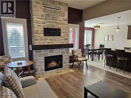Floor to ceiling stone gas fireplace - 98 Allandale Crescent, Simcoe, ON - Indoor Photo Showing Living Room With Fireplace