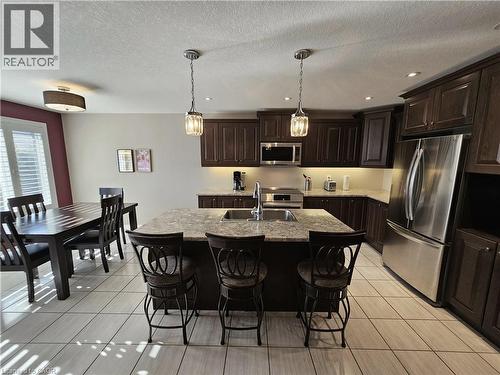 Island featuring a double sink and built-in dishwasher - 98 Allandale Crescent, Simcoe, ON - Indoor