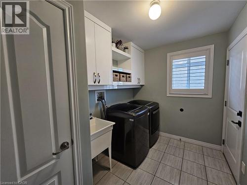 Main floor laundry room with access to the garage - 98 Allandale Crescent, Simcoe, ON - Indoor Photo Showing Laundry Room