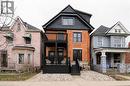 Brick facade with a contrasting black second-story balcony and trim - 249 Emerald Street N, Hamilton, ON 