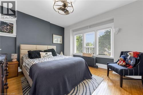 Hardwood flooring and a neutral color palette enhance this bright room - 110 Melrose Avenue S, Hamilton, ON 