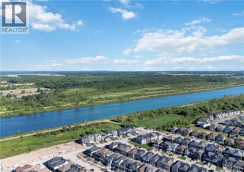 Aerial perspective showcasing a residential development alongside a prominent waterway - 66 Aviron Crescent, Welland, ON 