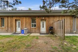 Side view of laundry room and Unit 2 entrance. - 