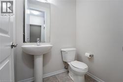 Bathroom featuring tile patterned flooring, toilet, and baseboards - 