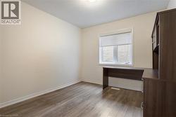 Unfurnished room with dark wood-style flooring, visible vents, a textured ceiling, and baseboards - 