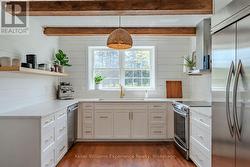 With custom cabinetry & crisp quartz countertops - 
