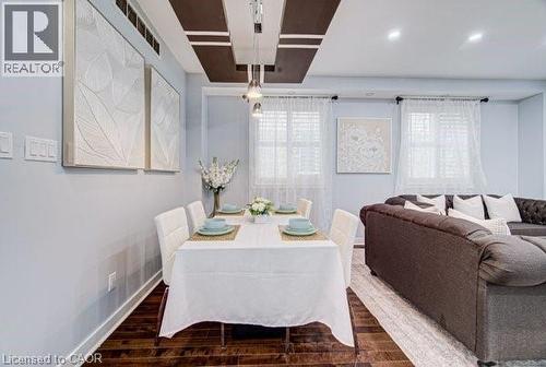 Dining area featuring wood-finish flooring and a contemporary drop ceiling design - 55 Isaiah Drive, Kitchener, ON 