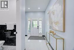 Entryway featuring white tile flooring and a paneled door with sidelights - 