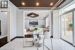 White large format tile flooring with dark border trim - 