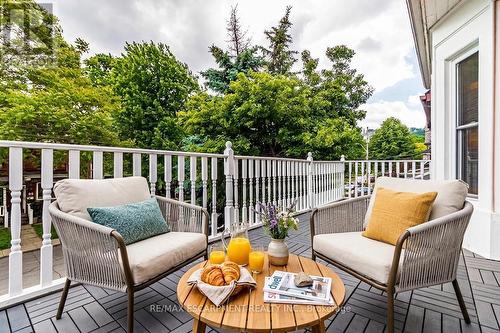 Front Balcony Virtually Staged from Bedroom - 82 Burris Street, Hamilton, ON 