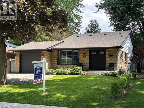 Brick exterior with a dark asphalt shingle roof - 39 Forestgate Drive, Hamilton, ON 