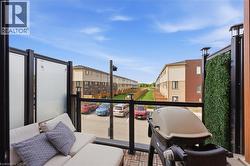 Outdoor balcony featuring wood-finish flooring and glass panel railings - 