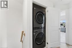 Built-in stackable laundry appliances within a dedicated closet - 