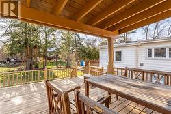 Spacious rear deck featuring a wood-finish floor and matching railings - 