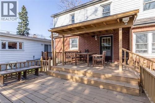 Multi-level wood deck featuring a covered porch area with a brick exterior - 17 Thorndale Street N, Hamilton, ON 