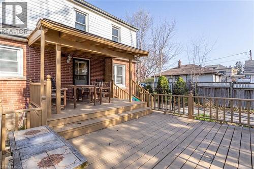 Multi-level wood deck featuring a covered patio area with a wood ceiling - 17 Thorndale Street N, Hamilton, ON 