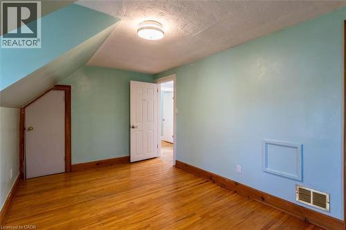 Hardwood flooring throughout, featuring natural wood baseboards and door trim - 17 Thorndale Street N, Hamilton, ON 