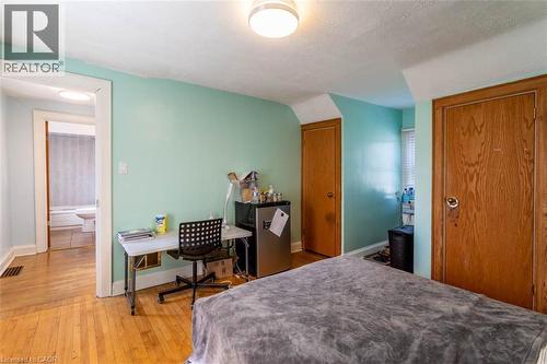 Room featuring light wood-finish flooring, light blue wall paint, and white trim - 17 Thorndale Street N, Hamilton, ON 