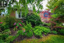 Beautifully landscaped with mature trees and perennials giving privacy. - 