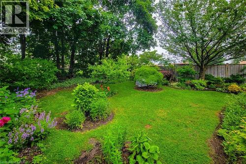 Expansive green lawn with established garden beds - 73 West 1St Street, Hamilton, ON 
