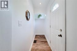 Main floor, bright entry hallway with laminate flooring. - 