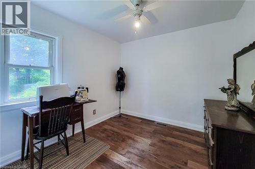 Room featuring wood-finish flooring, a double-hung window, white baseboards, and a ceiling fan with light fixture - 73 West 1St Street, Hamilton, ON 
