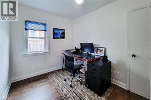 Bright room featuring a single window with blue blinds, white trim, and a white interior door - 73 West 1St Street, Hamilton, ON 