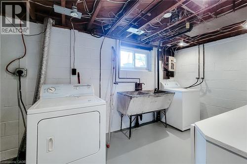 Utility area featuring painted concrete block walls and a window - 73 West 1St Street, Hamilton, ON 