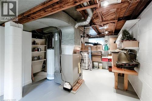 Basement utility area featuring exposed wood ceiling joists and painted block walls - 73 West 1St Street, Hamilton, ON 