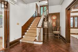 Grand entryway featuring wood-finish herringbone flooring - 