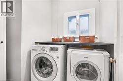 Dedicated laundry area featuring a built-in counter surface and an overhead window - 