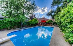 Rectangular inground pool with diving board and integrated steps - 
