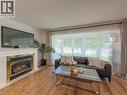 Living area with wood-finish flooring and a large picture window - 1324 Bodley Road, Mississauga, ON 