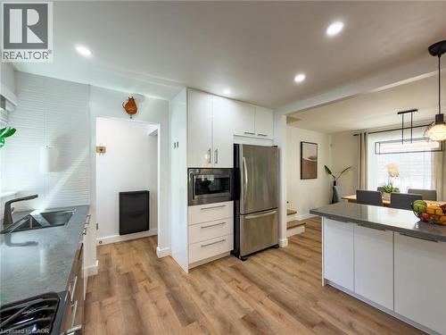 Modern kitchen featuring wood-finish flooring and recessed lighting - 1324 Bodley Road, Mississauga, ON 