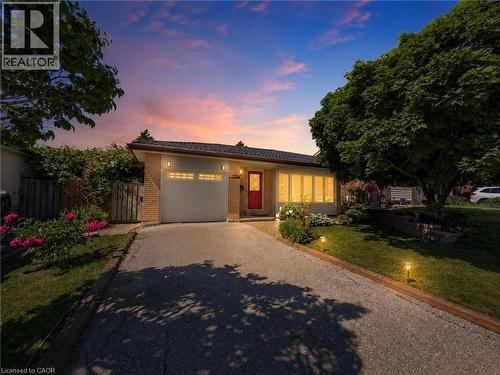 Brick and siding exterior featuring a prominent red entry door - 1324 Bodley Road, Mississauga, ON 