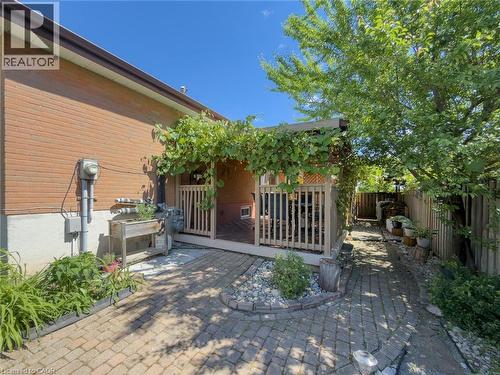 Brick exterior with a covered wood deck featuring a lattice privacy screen - 1324 Bodley Road, Mississauga, ON 