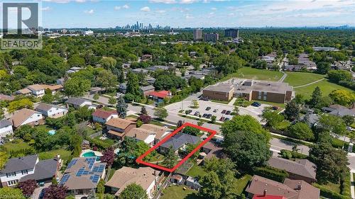 Aerial perspective showcasing a residential property with a dark-toned roof and surrounding mature trees - 1324 Bodley Road, Mississauga, ON 