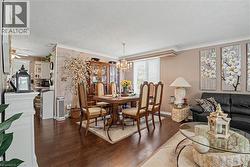 Open-concept living and dining areas featuring dark wood-finish flooring - 